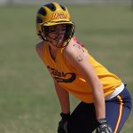 youth-softball-player-looking-at-base-coach-for-base-running-signals